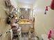 Cluttered bathroom with lots of toiletries, a mirror with lights, and a sink vanity at 792 Oneta Dr, Norcross, GA 30093