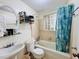 Cozy bathroom with a combination tub and shower, complemented by a unique glass-block window at 792 Oneta Dr, Norcross, GA 30093