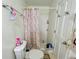 Modest bathroom features a shower/tub combo, floral shower curtain, and white fixtures at 792 Oneta Dr, Norcross, GA 30093