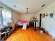 Bedroom with hardwood floors, natural light, and modern lighting fixture at 792 Oneta Dr, Norcross, GA 30093