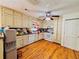 Kitchen with white appliances, wood floors, and ample cabinet space at 792 Oneta Dr, Norcross, GA 30093