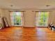 Bright living room featuring hardwood floors and two large windows at 792 Oneta Dr, Norcross, GA 30093