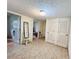 Hallway with tile floor, a mirrored chair, and multiple closet doors leading to adjacent rooms at 792 Oneta Dr, Norcross, GA 30093