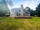 Large backyard with expansive lawn, deck, and lush, mature trees at 834 Winding Grove Ln, Loganville, GA 30052