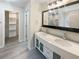 Bathroom featuring double vanity, large mirror, and walk-in closet at 834 Winding Grove Ln, Loganville, GA 30052