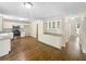 Bright kitchen with white cabinets, stainless steel appliances, and hardwood floors at 834 Winding Grove Ln, Loganville, GA 30052