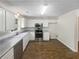 Spacious kitchen featuring stainless steel appliances, granite countertops, white cabinets, and wood flooring at 834 Winding Grove Ln, Loganville, GA 30052