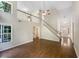 Bright living room featuring hardwood floors, staircase and natural light from windows with a ceiling fan at 834 Winding Grove Ln, Loganville, GA 30052