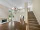 Open-concept living room with hardwood floors, fireplace, high ceilings and natural light from windows at 834 Winding Grove Ln, Loganville, GA 30052