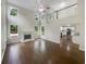 Bright living room with fireplace, tall windows, ceiling fan, and wood flooring at 834 Winding Grove Ln, Loganville, GA 30052