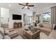 Bright living room features hardwood floors, a comfortable sofa, and a large window at 1107 Rivard Nw Cir, Atlanta, GA 30318