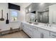 Elegant bathroom with double sinks, a large mirror, and a tiled shower with a glass door at 1109 Rivard Nw Cir, Atlanta, GA 30318