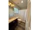 Bright bathroom featuring a vanity with granite countertops, a large mirror, and a shower with curtain at 2167 Del Lago Cir # 11, Kennesaw, GA 30152