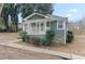 Charming green bungalow featuring a welcoming front porch and stone foundation accents at 246 Aurora Nw Ave, Atlanta, GA 30314