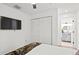 Bright bedroom featuring a flat-screen TV, hardwood floors, and access to the bathroom at 251 Aurora Nw Ave, Atlanta, GA 30314