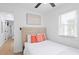Bright bedroom with a window, a ceiling fan, and a bed with an upholstered headboard at 251 Aurora Nw Ave, Atlanta, GA 30314