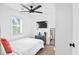 Bright bedroom with a ceiling fan, TV, and window providing lots of natural light at 251 Aurora Nw Ave, Atlanta, GA 30314