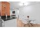 Dining area adjacent to the kitchen with a glass table and modern chairs at 251 Aurora Nw Ave, Atlanta, GA 30314