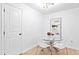 Modern dining area with a glass table and stylish white chairs at 251 Aurora Nw Ave, Atlanta, GA 30314