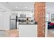 Bright kitchen featuring stainless steel appliances, white cabinetry, and a decorative brick pillar at 251 Aurora Nw Ave, Atlanta, GA 30314