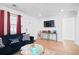 Cozy living room with a dark sofa, and wall-mounted TV at 251 Aurora Nw Ave, Atlanta, GA 30314