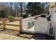 Back yard with wooden fence and a deck with chairs at 2184 E Cherokee Dr, Woodstock, GA 30188