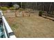 Back yard features a wooden fence with a gate and trees in the background at 2184 E Cherokee Dr, Woodstock, GA 30188