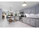 Bright kitchen boasts gray cabinets, stainless appliances, and a marble island at 2184 E Cherokee Dr, Woodstock, GA 30188