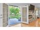 View of the patio and backyard through the glass doors adjacent to the fireplace at 2702 Moorings Pkwy, Snellville, GA 30039
