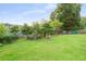 Lush backyard featuring mature trees, shrubs, and green lawn, offering a private outdoor space at 2702 Moorings Pkwy, Snellville, GA 30039
