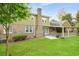 Charming two-story home with a spacious backyard featuring a patio, brick accents, and lush lawn at 2702 Moorings Pkwy, Snellville, GA 30039