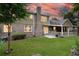 Spacious backyard with covered patio, lush lawn, and mature trees, perfect for relaxation or entertaining at 2702 Moorings Pkwy, Snellville, GA 30039