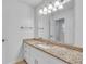 Bathroom with large mirror over granite countertops, and tiled flooring at 2702 Moorings Pkwy, Snellville, GA 30039