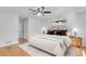 Well-lit bedroom with a ceiling fan, hardwood floors, and comfortable furnishings at 2702 Moorings Pkwy, Snellville, GA 30039