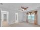 Bedroom features neutral carpet, large window with wood-toned curtains, and two doorways at 2702 Moorings Pkwy, Snellville, GA 30039