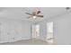 Bedroom features a ceiling fan, neutral carpet, and access to the ensuite bathroom at 2702 Moorings Pkwy, Snellville, GA 30039