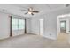 Bedroom featuring a large window, neutral carpet and an open doorway to another room at 2702 Moorings Pkwy, Snellville, GA 30039