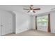 Carpeted bedroom features a large window with wood-toned curtains at 2702 Moorings Pkwy, Snellville, GA 30039