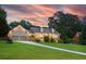 Beautiful brick home with dormer windows, complemented by a manicured lawn and elegant driveway at 2702 Moorings Pkwy, Snellville, GA 30039