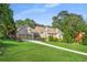 Charming brick home with a well-manicured lawn, dormer windows and a long driveway leading to a two-car garage at 2702 Moorings Pkwy, Snellville, GA 30039