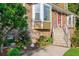 Close-up of a brick home featuring a beautiful garden, dormer windows and an inviting stairway at 2702 Moorings Pkwy, Snellville, GA 30039