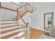 Elegant foyer with hardwood floors, staircase, chandelier, and high ceiling, creating a grand entrance at 2702 Moorings Pkwy, Snellville, GA 30039