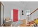 Bright foyer with hardwood floors, a red front door, a staircase, and a high ceiling with chandelier at 2702 Moorings Pkwy, Snellville, GA 30039