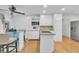 Charming kitchen features white cabinets, stainless steel appliances, granite countertops, and an eat-in glass table at 2702 Moorings Pkwy, Snellville, GA 30039