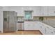 Modern kitchen with stainless steel appliances, granite countertops, and white cabinetry at 2702 Moorings Pkwy, Snellville, GA 30039