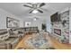 Bright living room with a brick fireplace and hardwood floors, perfect for gatherings at 2702 Moorings Pkwy, Snellville, GA 30039