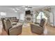 Cozy living room with fireplace, hardwood floors, and comfortable seating arrangement at 2702 Moorings Pkwy, Snellville, GA 30039