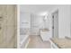 This bathroom includes white cabinets, granite countertops, and a soaking tub with marble tile at 2702 Moorings Pkwy, Snellville, GA 30039