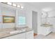 Bright bathroom featuring dual sinks with granite counters, white cabinets and tile floors at 2702 Moorings Pkwy, Snellville, GA 30039