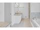 This bathroom features granite countertops, white cabinets, tub and glass enclosed shower at 2702 Moorings Pkwy, Snellville, GA 30039